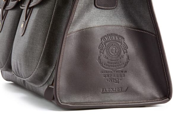 Ghurka handmade leather bag image focused on the unique custom Flexjet labeling on outside